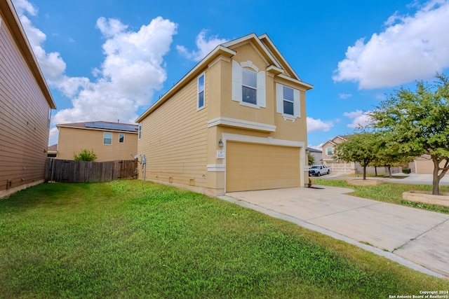 view of side of home with a garage and a lawn