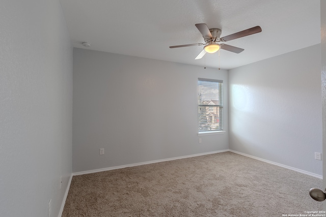 spare room featuring carpet floors and ceiling fan