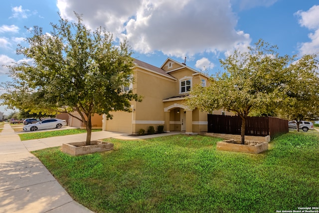 view of front of house with a front yard and a garage