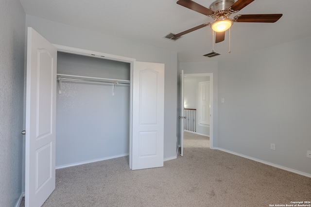 unfurnished bedroom featuring a closet, ceiling fan, and light carpet