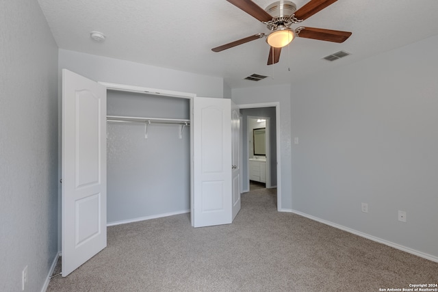 unfurnished bedroom with a closet, light colored carpet, and ceiling fan