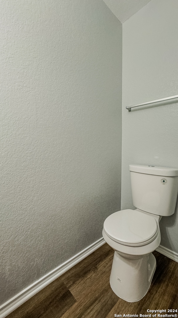 bathroom featuring hardwood / wood-style floors and toilet