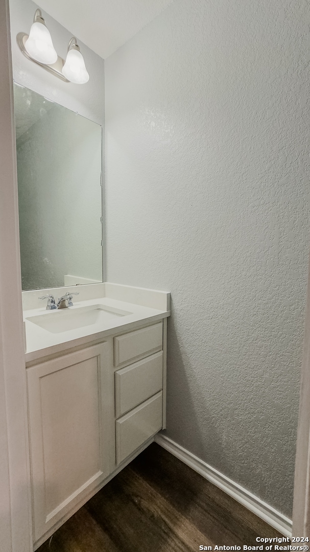 bathroom featuring vanity and hardwood / wood-style flooring