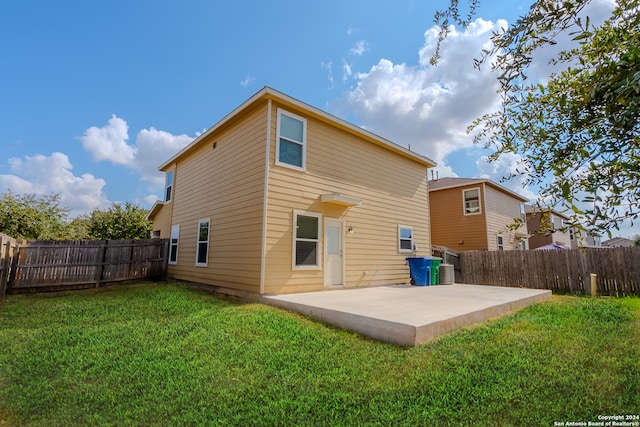 back of property featuring a patio area and a lawn