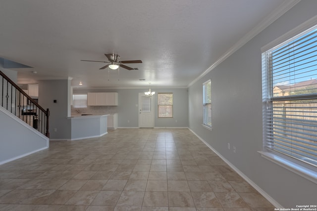 unfurnished living room with crown molding, ceiling fan with notable chandelier, and light tile patterned floors