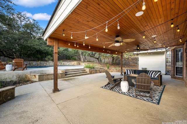 view of patio with ceiling fan and a pool