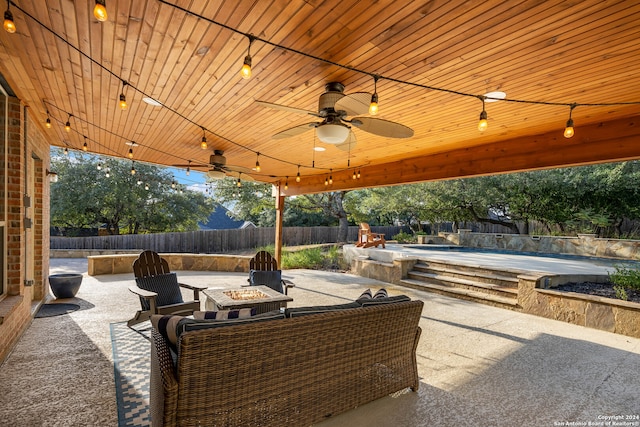 view of patio featuring a jacuzzi, a fire pit, and ceiling fan