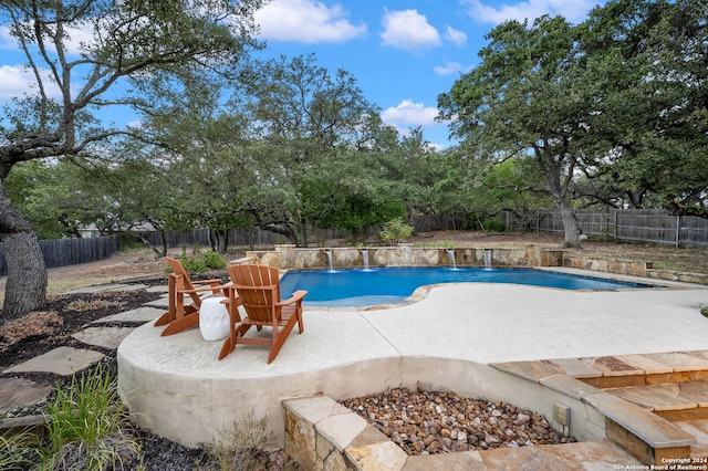 view of swimming pool featuring an outdoor fire pit, a patio area, and pool water feature