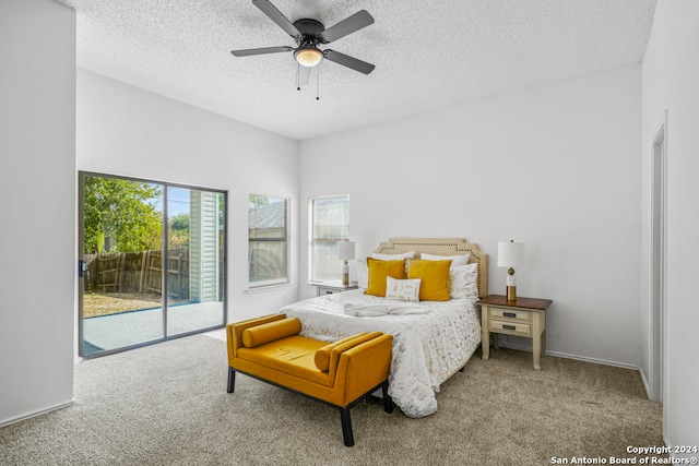 carpeted bedroom with a textured ceiling, access to exterior, and ceiling fan