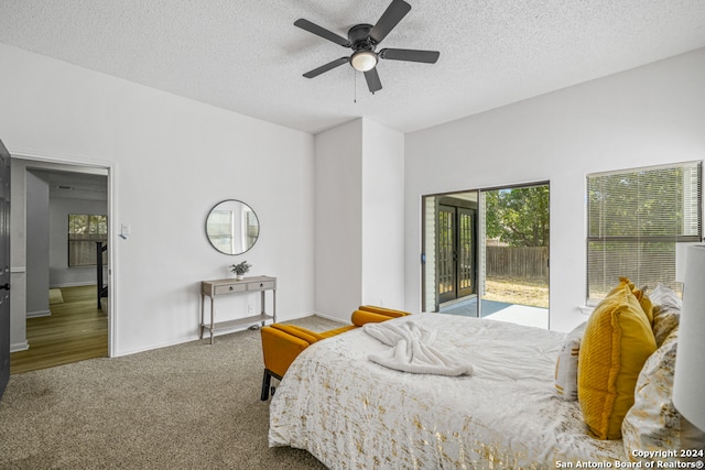 carpeted bedroom featuring ceiling fan, access to outside, and a textured ceiling