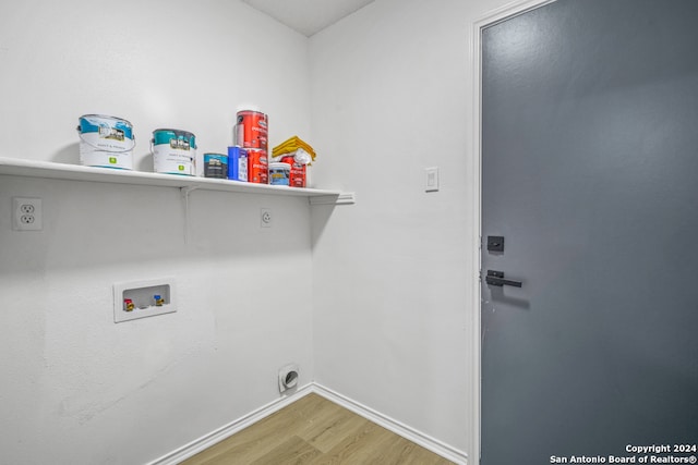 washroom with hookup for a washing machine, electric dryer hookup, and wood-type flooring