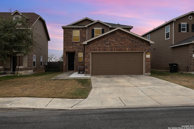 front facade with a garage and a lawn