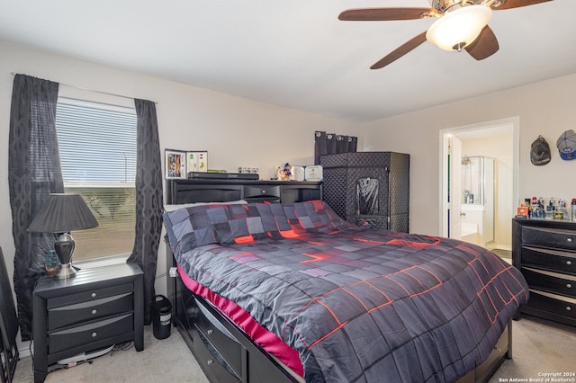 carpeted bedroom featuring ceiling fan and ensuite bathroom