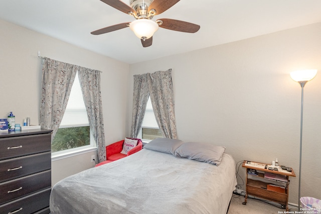 bedroom featuring ceiling fan and light carpet