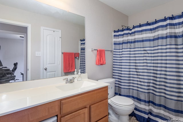 bathroom featuring toilet, walk in shower, and vanity