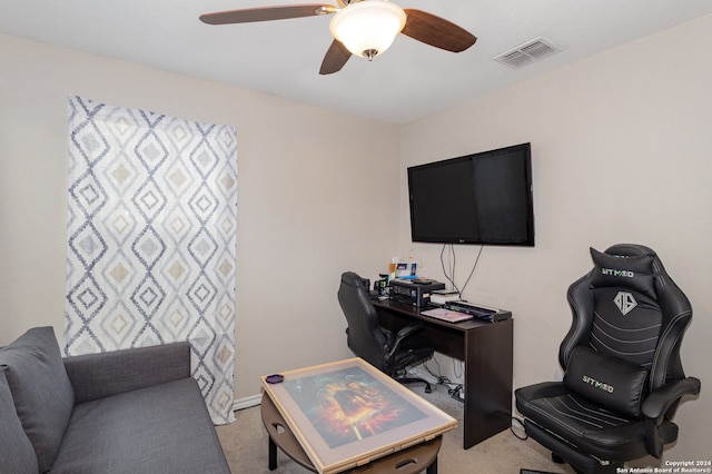 office area featuring light carpet and ceiling fan