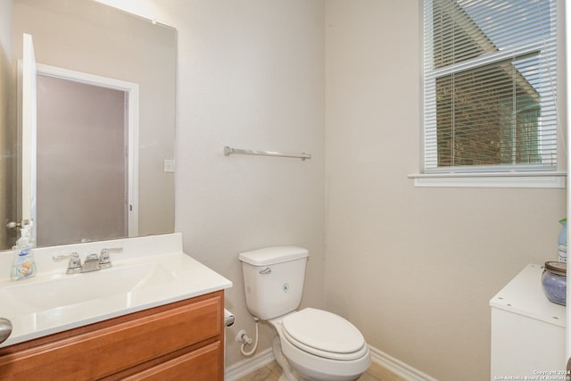 bathroom featuring vanity, toilet, and tile patterned flooring