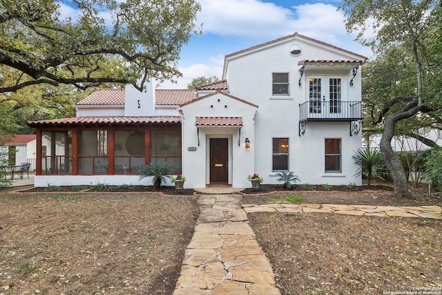 mediterranean / spanish-style home featuring a sunroom