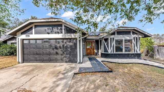 view of front of property featuring a garage and solar panels