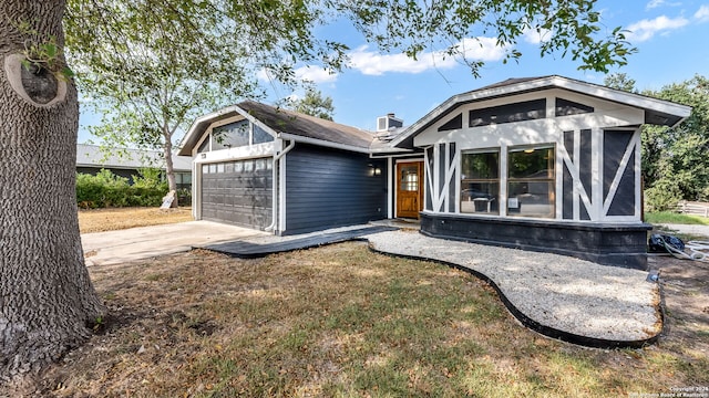 7935 Sonny Rdg, San Antonio, TX 78244 - view of front of home with an attached garage, driveway, and a chimney