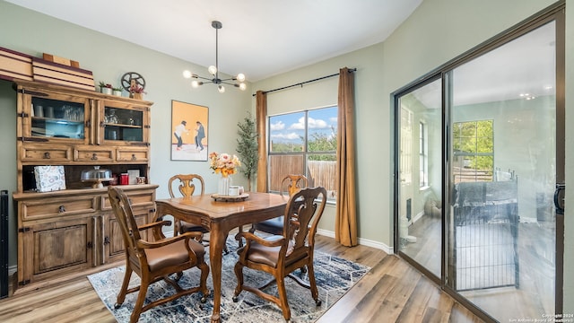 dining space with an inviting chandelier and light wood-type flooring