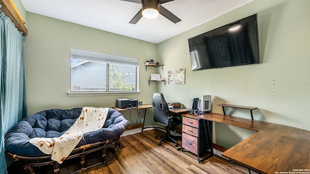 home office with hardwood / wood-style floors and ceiling fan