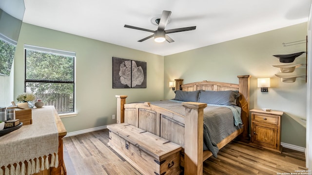 bedroom with light hardwood / wood-style floors and ceiling fan