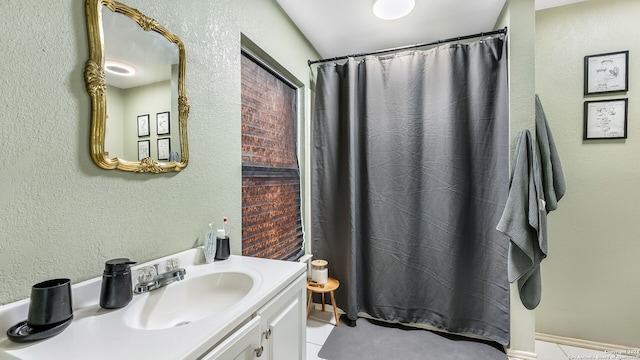 bathroom with tile patterned flooring, vanity, and a shower with curtain