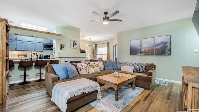 living room featuring ceiling fan and light hardwood / wood-style floors