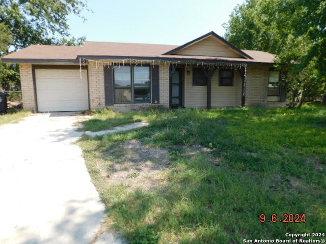 single story home with a front lawn and a garage