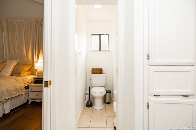 bathroom with toilet and wood-type flooring