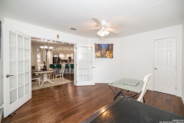 office with french doors, dark wood-type flooring, and ceiling fan with notable chandelier