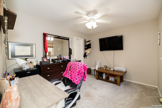 home office with ceiling fan, light colored carpet, and a textured ceiling