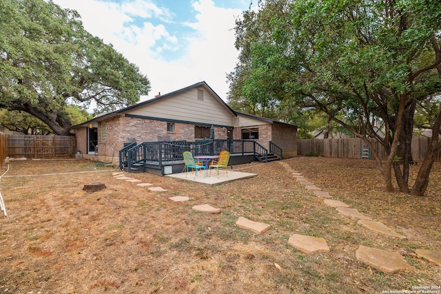 rear view of property with a patio area and a deck