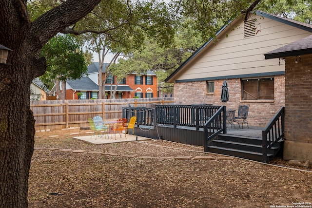 rear view of house featuring a wooden deck, a patio area, and central AC unit