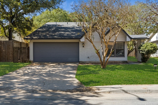 view of front of home with a front yard and a garage