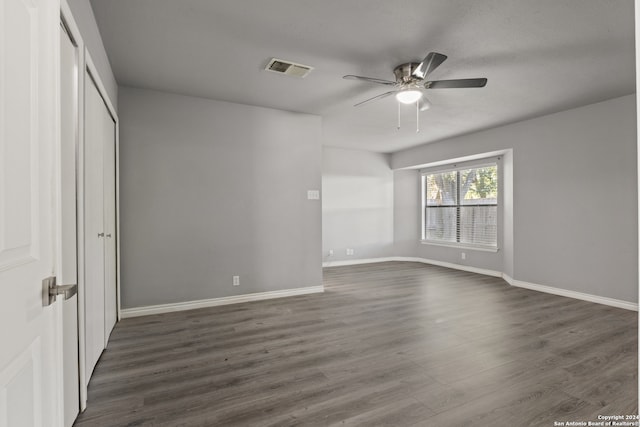 unfurnished bedroom featuring dark hardwood / wood-style floors and ceiling fan