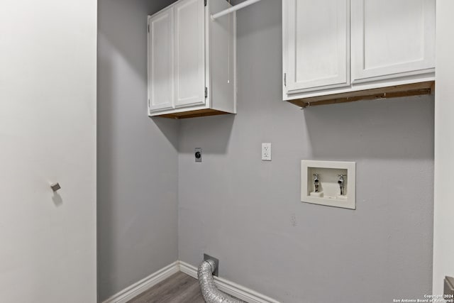 laundry room with cabinets, hardwood / wood-style floors, washer hookup, and electric dryer hookup