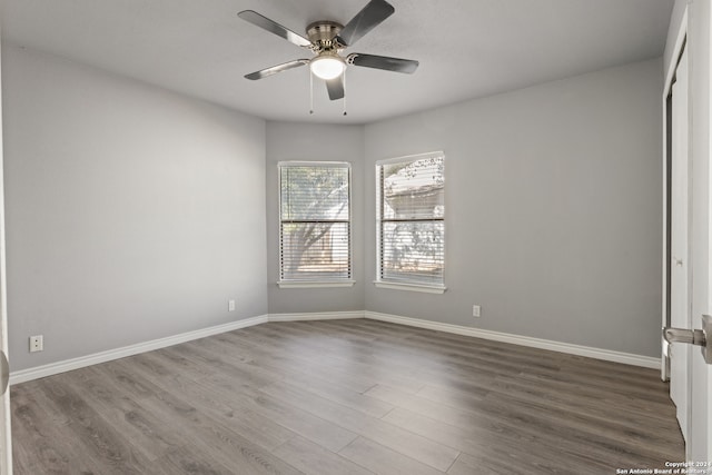 spare room featuring wood-type flooring and ceiling fan