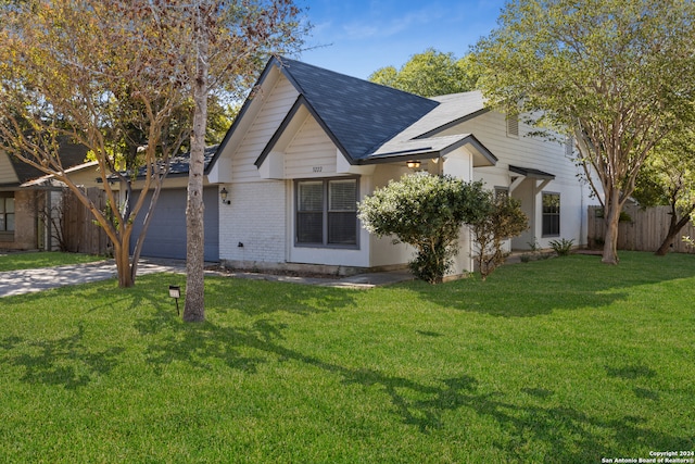 view of front of home with a front yard and a garage