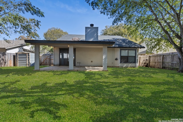 back of property featuring a patio area, a storage shed, and a lawn