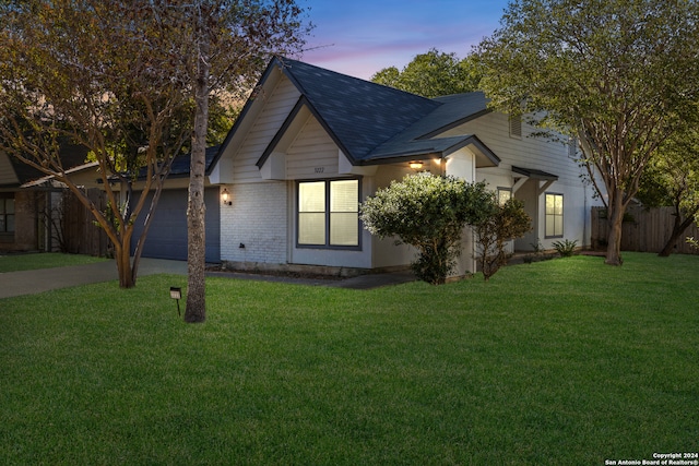 view of front of house with a garage and a lawn