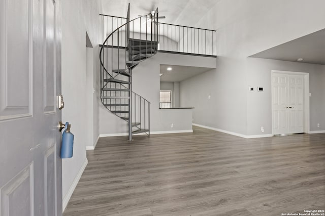 entrance foyer with wood-type flooring and a high ceiling