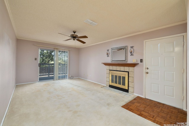 unfurnished living room featuring ornamental molding, a tiled fireplace, a textured ceiling, and ceiling fan