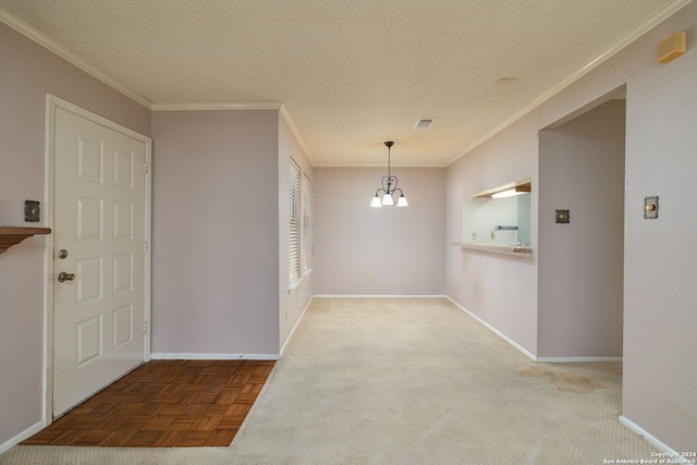 entrance foyer with ornamental molding, an inviting chandelier, parquet floors, and a textured ceiling