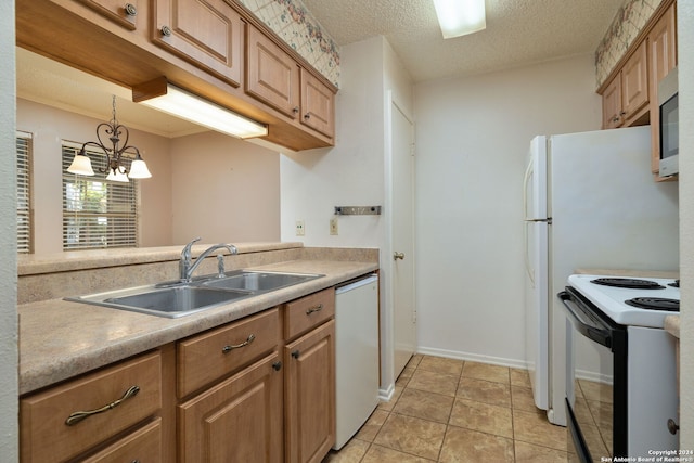 kitchen with hanging light fixtures, light tile patterned floors, an inviting chandelier, sink, and white appliances