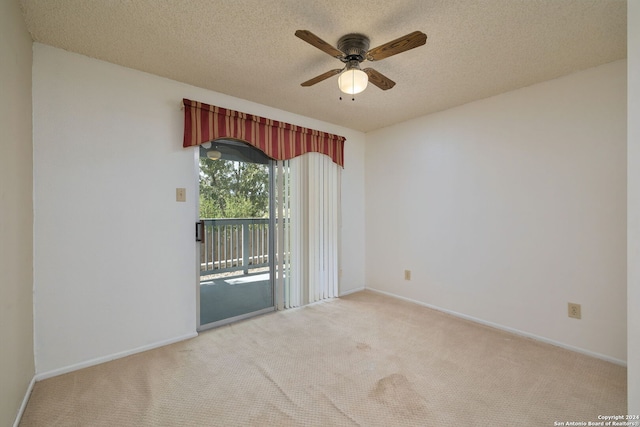 spare room featuring light carpet, a textured ceiling, and ceiling fan