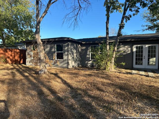 view of side of home featuring french doors