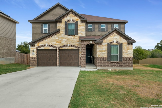 view of front of home featuring a front yard and a garage