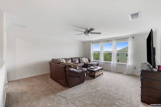 carpeted living room featuring ceiling fan